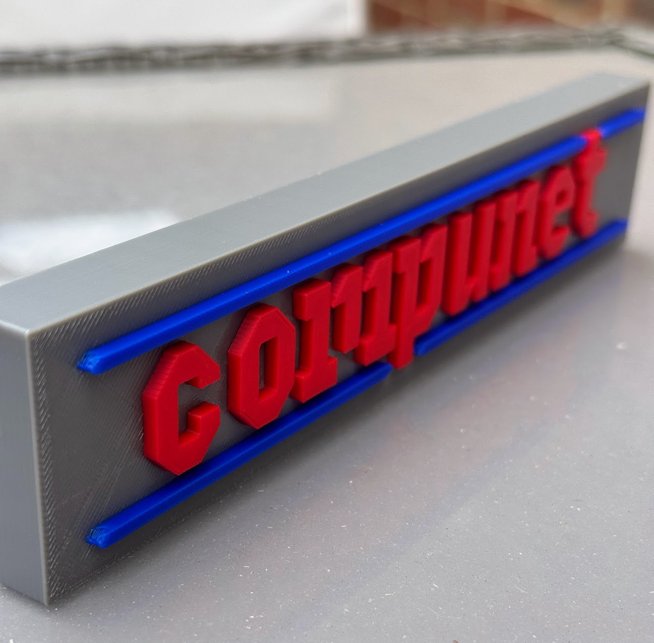 The same plaque at an angle, showing the lettering standing proud of the surface
